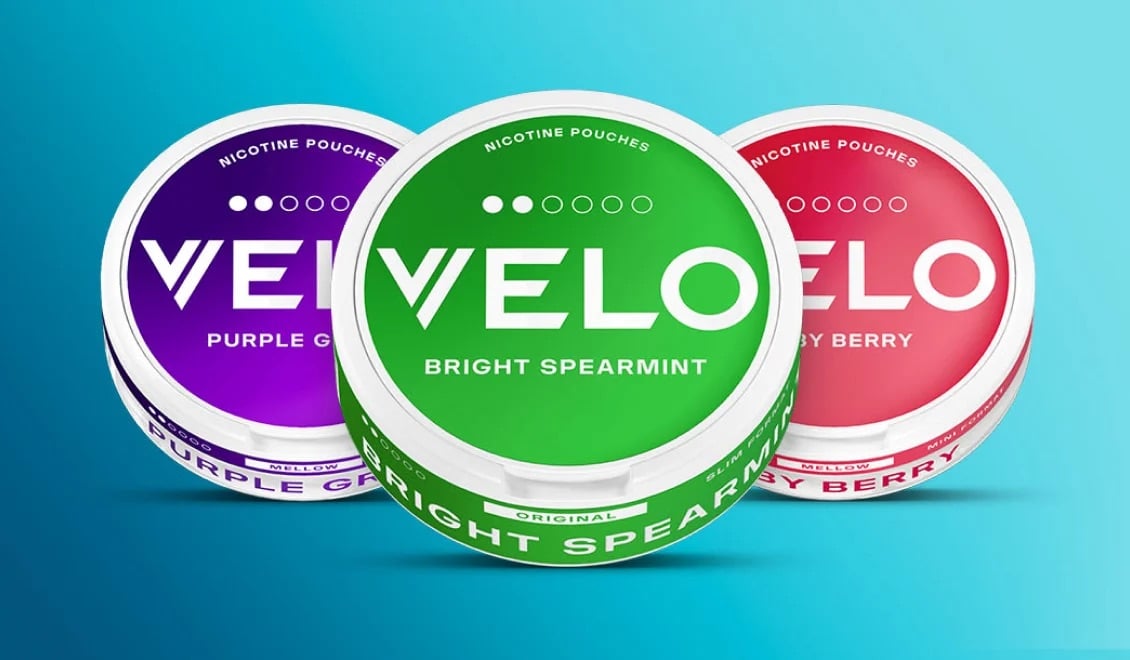 Velo tins on a blue backdrop